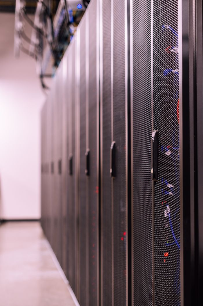 about-05 Row of similar lockers with various optic fiber cables in modern data server room
