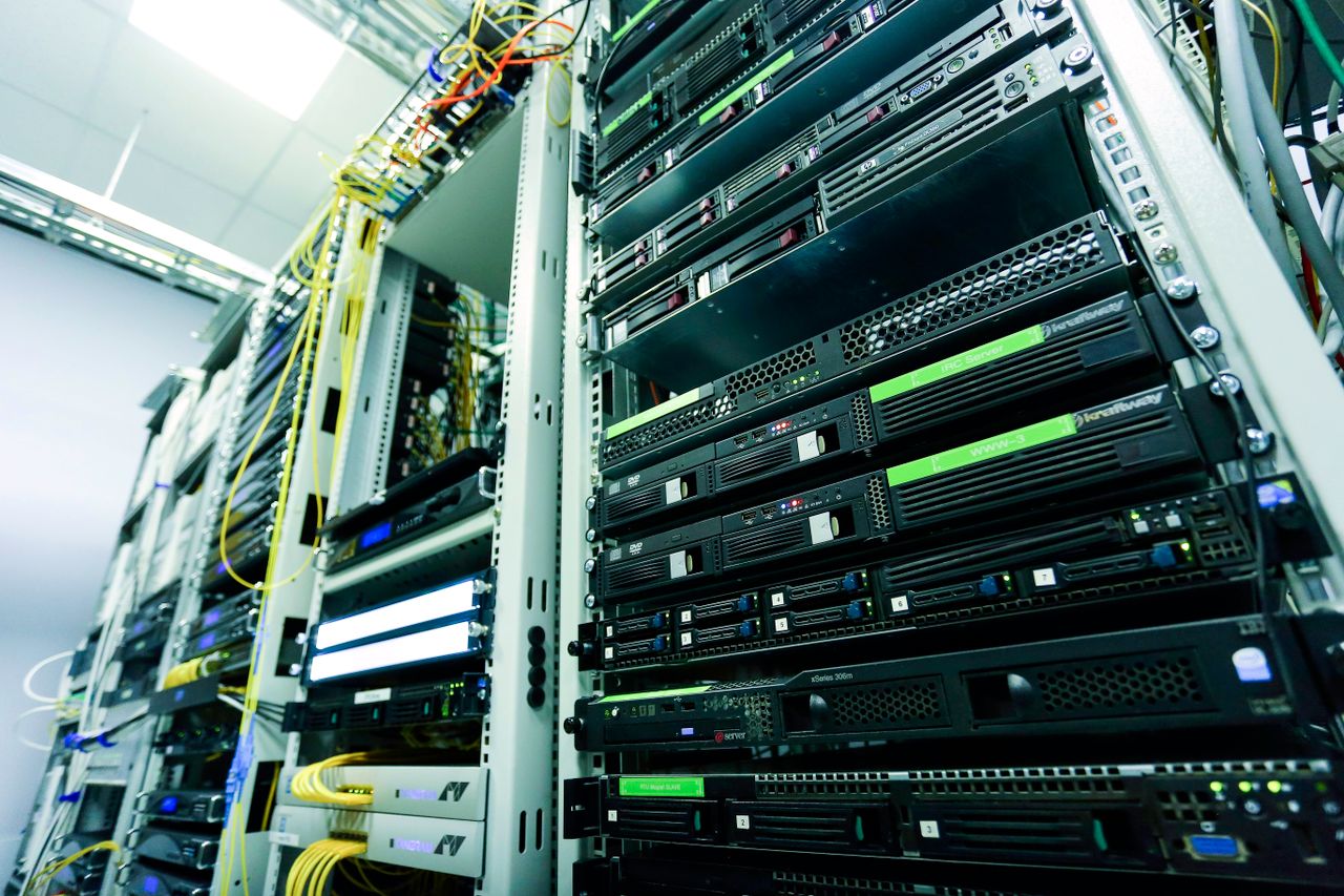 services-01 High-tech server rack in a secure data center with network cables and hardware components.